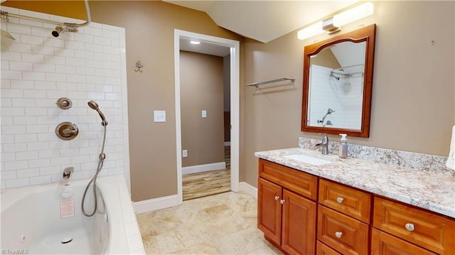 bathroom featuring baseboards, vanity, and shower / washtub combination