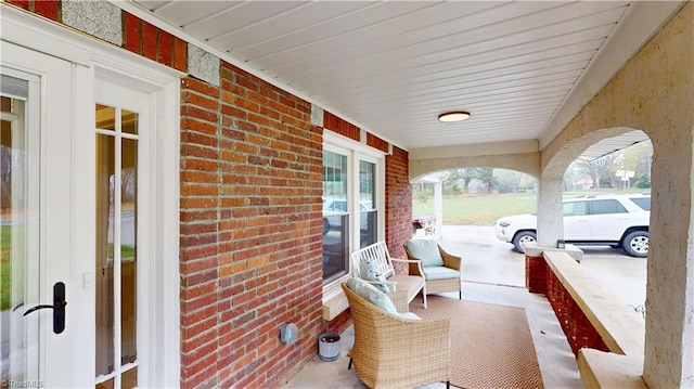 view of patio with covered porch and a carport