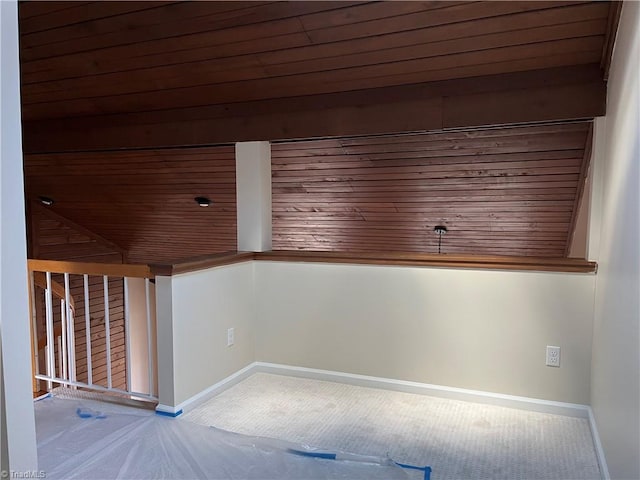 unfurnished room with stairway, wood ceiling, and baseboards