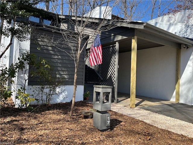 view of home's exterior with a carport