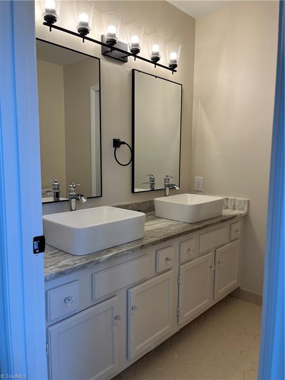 bathroom featuring double vanity and a sink