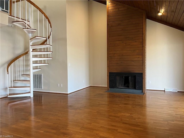 unfurnished living room featuring wooden ceiling, visible vents, a large fireplace, and wood finished floors