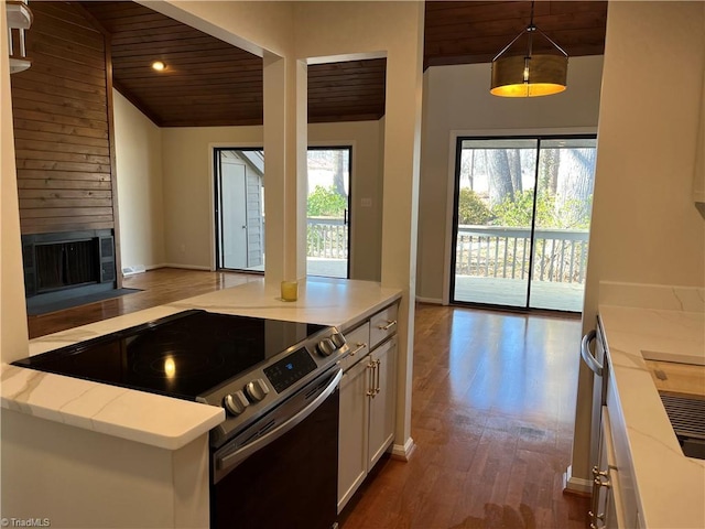 kitchen featuring stainless steel electric stove, light stone countertops, a fireplace with flush hearth, wood ceiling, and wood finished floors