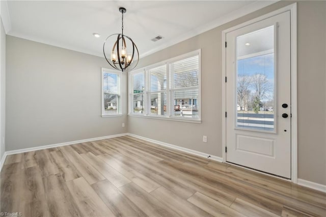 interior space featuring ornamental molding, light wood-style flooring, visible vents, and an inviting chandelier