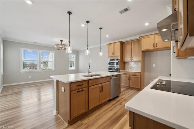 kitchen with stainless steel appliances, a sink, visible vents, light countertops, and crown molding