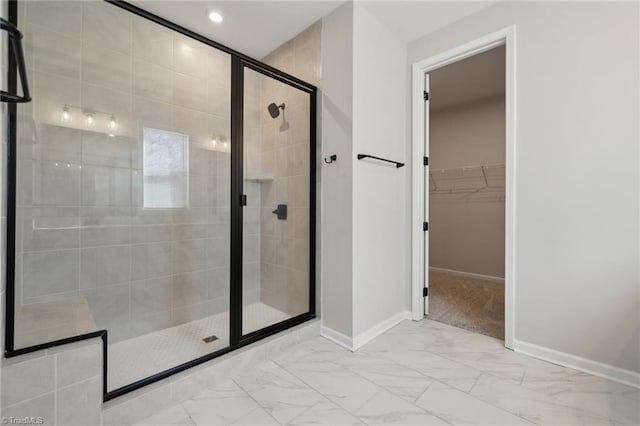 bathroom with recessed lighting, baseboards, marble finish floor, a shower stall, and a walk in closet