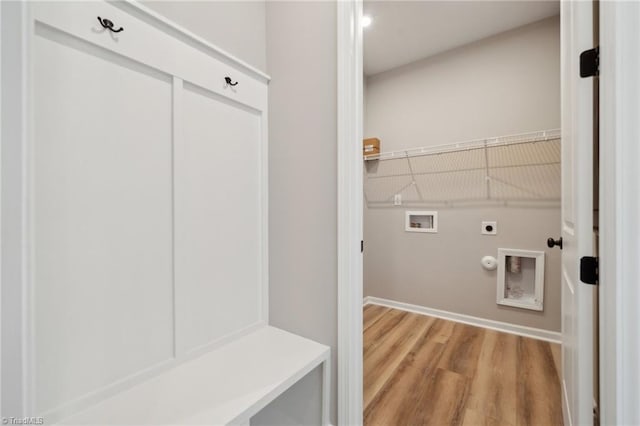 washroom with laundry area, gas dryer hookup, light wood-style flooring, hookup for a washing machine, and electric dryer hookup