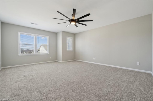 unfurnished room featuring ceiling fan, carpet flooring, visible vents, and baseboards