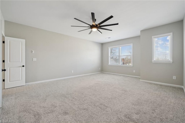 unfurnished room featuring carpet flooring, ceiling fan, and baseboards