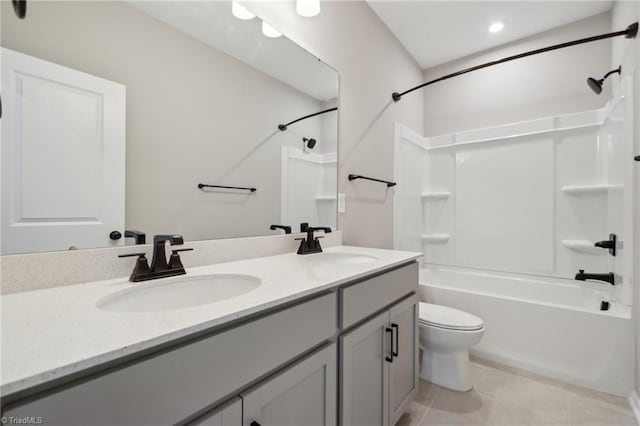 bathroom with toilet, a sink, tub / shower combination, tile patterned floors, and double vanity