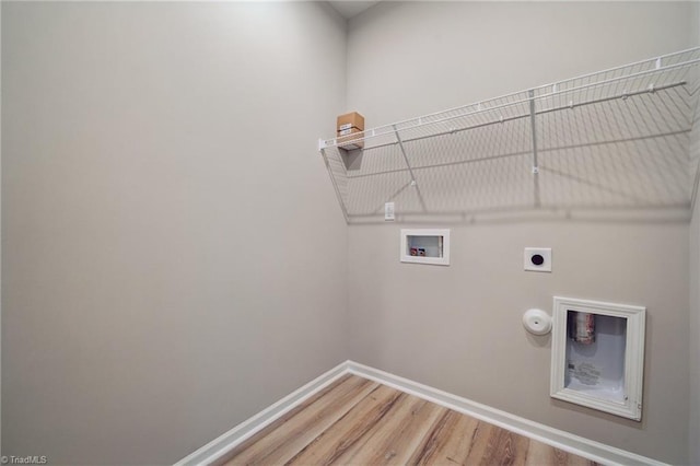 clothes washing area featuring gas dryer hookup, hookup for a washing machine, laundry area, baseboards, and electric dryer hookup