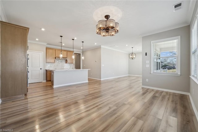 unfurnished living room featuring baseboards, light wood finished floors, visible vents, and an inviting chandelier