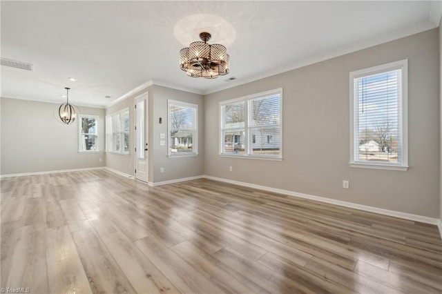 interior space with visible vents, baseboards, light wood-style flooring, an inviting chandelier, and crown molding