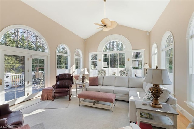 sunroom featuring ceiling fan and vaulted ceiling