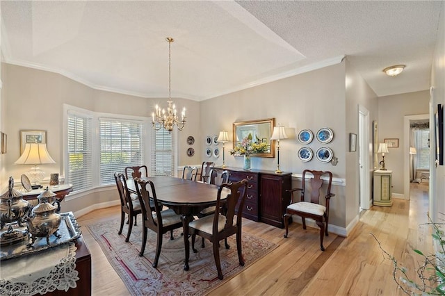 dining room with baseboards, a notable chandelier, light wood-style flooring, and a textured ceiling