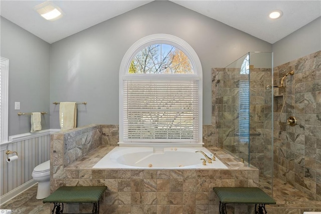 full bath featuring walk in shower, a jetted tub, a wealth of natural light, and vaulted ceiling