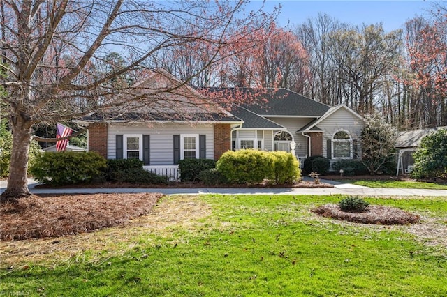 ranch-style house with brick siding and a front yard