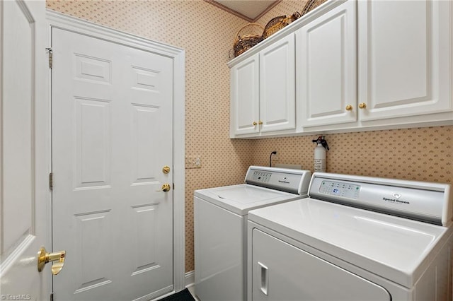 clothes washing area with cabinet space, independent washer and dryer, and wallpapered walls