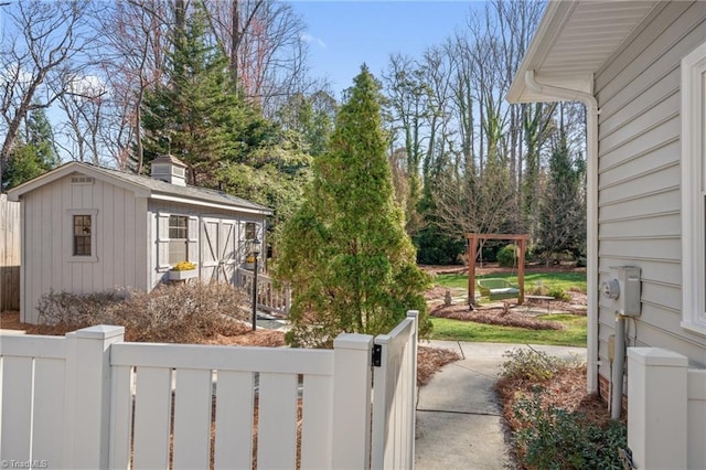 view of yard featuring a fenced front yard and an outdoor structure