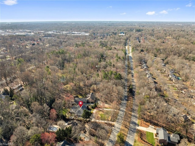 drone / aerial view featuring a wooded view