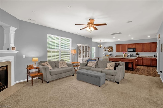 1420 Joyceland Rd, Kernersville, NC 27284 - carpeted living room with baseboards, recessed lighting, ceiling fan with notable chandelier, and a premium fireplace