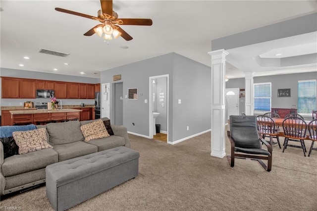 1420 Joyceland Rd, Kernersville, NC 27284 - living room featuring recessed lighting, visible vents, baseboards, decorative columns, and light colored carpet