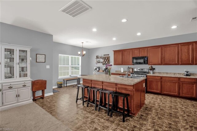 1420 Joyceland Rd, Kernersville, NC 27284 - kitchen with a sink, brown cabinetry, black microwave, visible vents, and recessed lighting