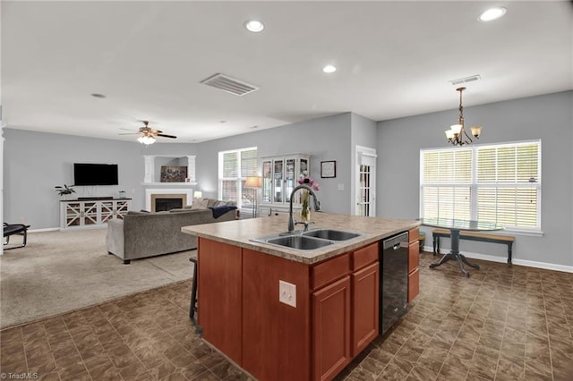 1420 Joyceland Rd, Kernersville, NC 27284 - kitchen with a sink, ceiling fan with notable chandelier, a fireplace, visible vents, and recessed lighting