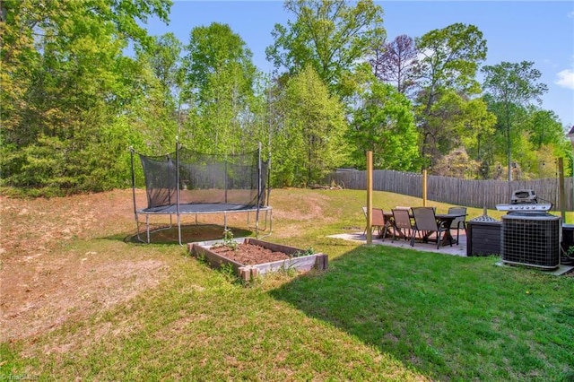1420 Joyceland Rd, Kernersville, NC 27284 - view of yard with central air condition unit, fence, a patio, and a trampoline