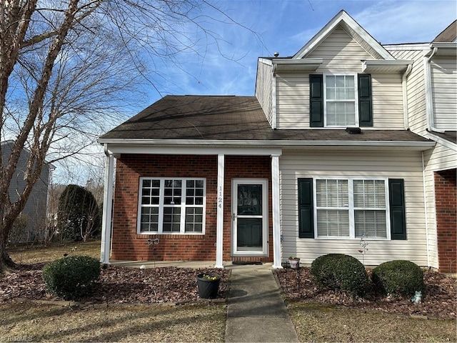 traditional home featuring brick siding