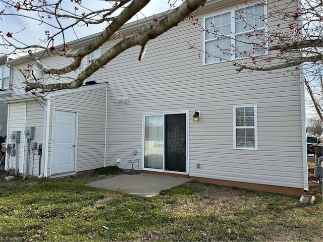 back of property with a patio and a lawn