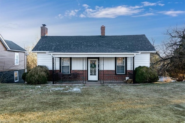 bungalow-style house featuring a front yard and covered porch