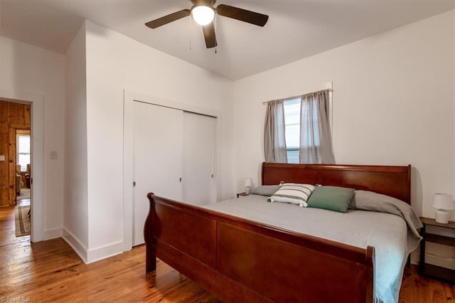 bedroom featuring a closet, ceiling fan, and light hardwood / wood-style flooring