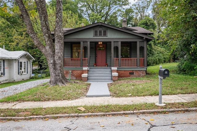 bungalow-style home with a front lawn and a porch