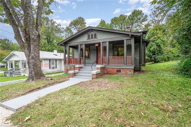 bungalow with a front lawn and a porch