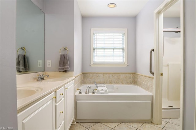 5711 Beaver Pond Trl, Pfafftown, NC 27040 - bathroom with tile patterned flooring, double vanity, a garden tub, and a stall shower