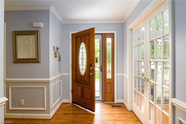 5711 Beaver Pond Trl, Pfafftown, NC 27040 - foyer with wood finished floors, wainscoting, and ornamental molding