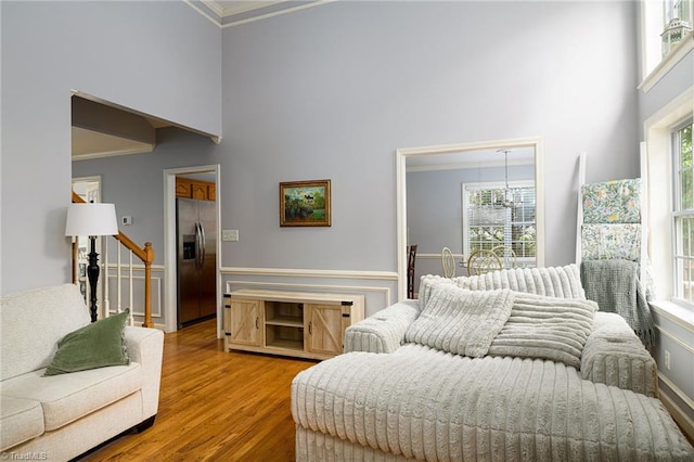 5711 Beaver Pond Trl, Pfafftown, NC 27040 - living room featuring a towering ceiling, ornamental molding, and wood finished floors