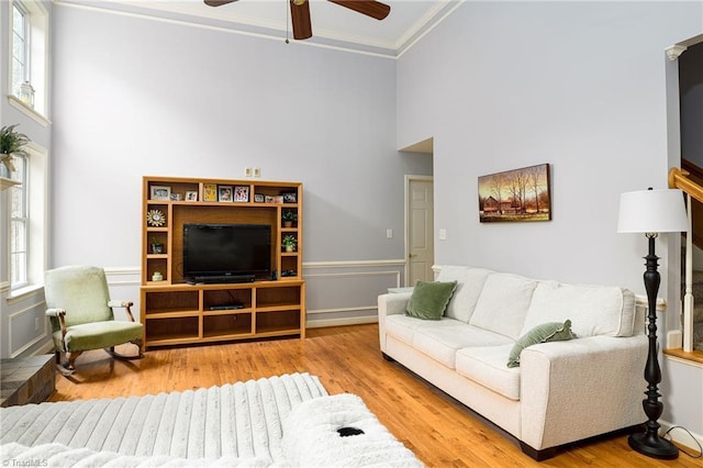 5711 Beaver Pond Trl, Pfafftown, NC 27040 - living area featuring a ceiling fan, crown molding, wood finished floors, and a high ceiling