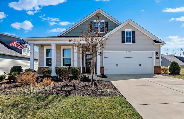 craftsman-style home with covered porch, driveway, a front yard, and a garage