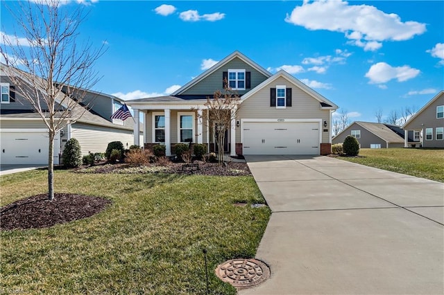 view of front of home with a porch, an attached garage, driveway, and a front lawn