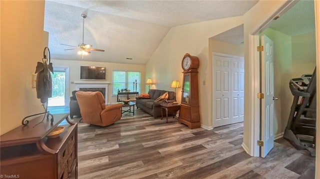 4401 Barndale Ct, Jamestown, NC 27282 - living area with wood finished floors, ceiling fan, a fireplace, lofted ceiling, and a textured ceiling