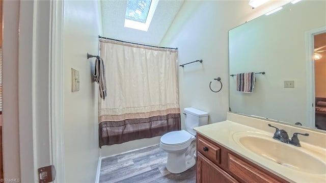 4401 Barndale Ct, Jamestown, NC 27282 - bathroom featuring a skylight, wood finished floors, vanity, shower / bath combination with curtain, and lofted ceiling