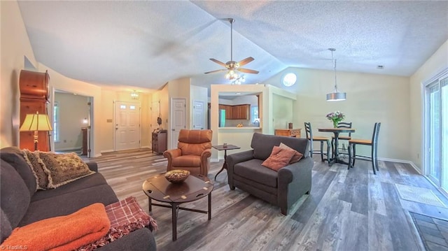 4401 Barndale Ct, Jamestown, NC 27282 - living room with wood finished floors, a ceiling fan, vaulted ceiling, and a textured ceiling