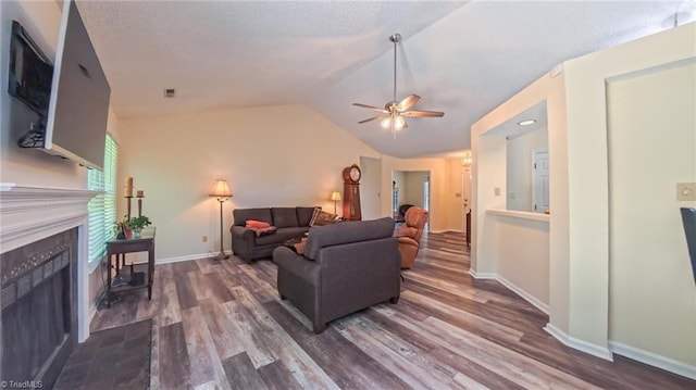 4401 Barndale Ct, Jamestown, NC 27282 - living area featuring dark wood-type flooring, a ceiling fan, vaulted ceiling, and a fireplace
