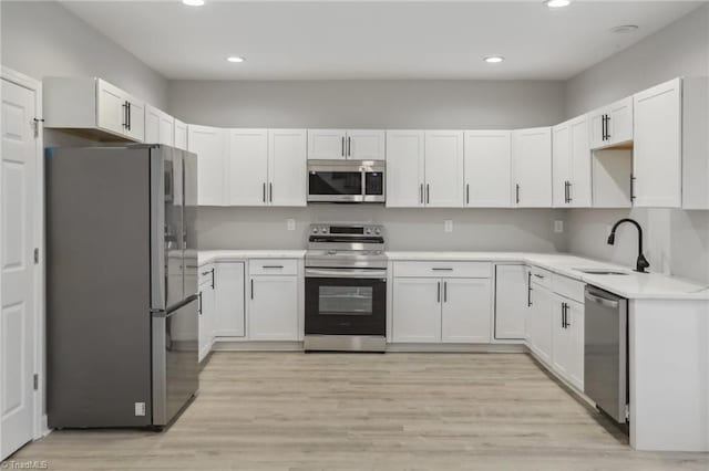 kitchen with white cabinetry, sink, and appliances with stainless steel finishes