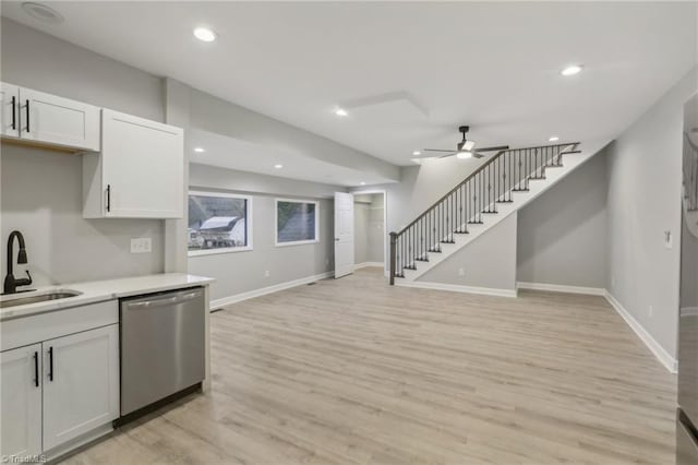 kitchen with white cabinets, sink, light hardwood / wood-style flooring, stainless steel dishwasher, and ceiling fan