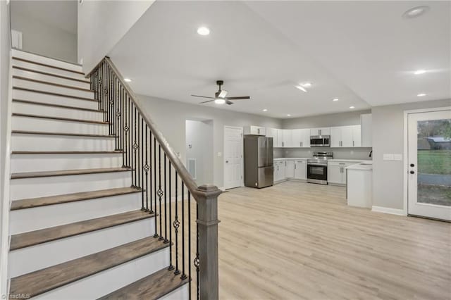 interior space with wood-type flooring and ceiling fan