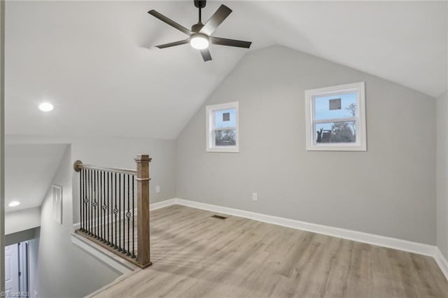 bonus room featuring light hardwood / wood-style floors, vaulted ceiling, and ceiling fan