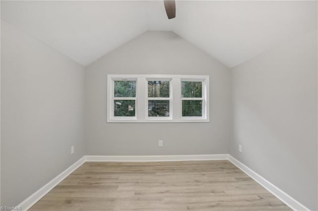 additional living space with light wood-type flooring and lofted ceiling